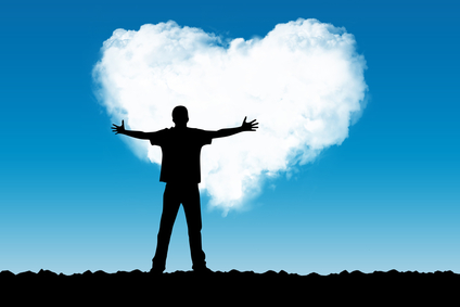 The person stretches hands to a cloud in the form of heart